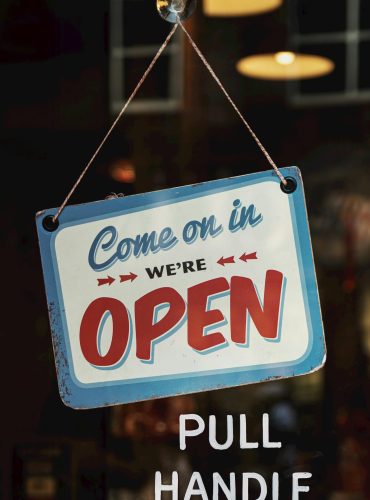 Vintage-style open sign welcoming customers into a Nashville shop. Perfect for illustrating business atmosphere.
